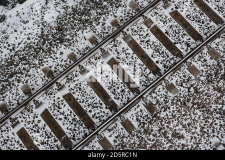 Overhead view of railway tracks with snow on ground Stock Photo