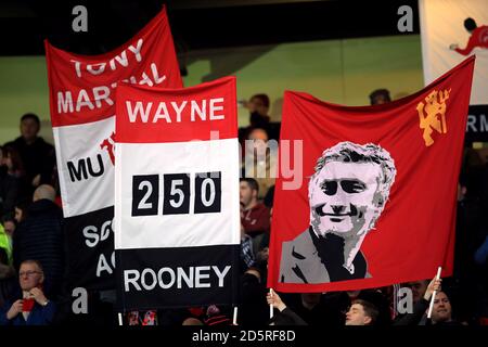 Manchester United fans with banners in the stands Stock Photo