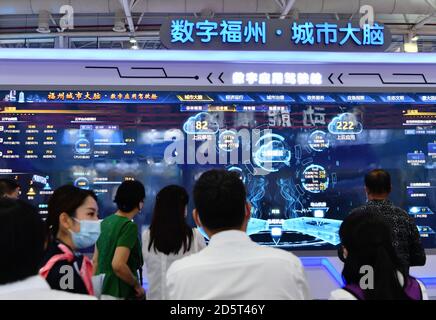 Fuzhou. 14th Oct, 2020. Photo taken on Oct. 14, 2020 shows visitors at an achievement expo on the 3rd Digital China Summit in Fuzhou, capital of southeast China's Fujian Province. The 3rd Digital China Summit closed in Fuzhou on Wednesday. A total of 426 projects in the digital sector involving a total investment of 331.6 billion yuan (about 49 billion U.S. dollars) were signed at this year's Digital China Summit. The projects cover fields such as artificial intelligence, 5G, industrial Internet, and blockchain. Credit: Xinhua/Alamy Live News Stock Photo