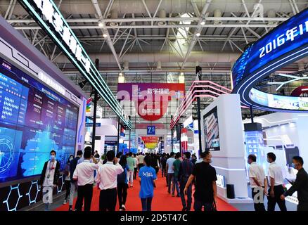 Fuzhou. 14th Oct, 2020. Photo taken on Oct. 14, 2020 shows visitors at an achievement expo on the 3rd Digital China Summit in Fuzhou, capital of southeast China's Fujian Province. The 3rd Digital China Summit closed in Fuzhou on Wednesday. A total of 426 projects in the digital sector involving a total investment of 331.6 billion yuan (about 49 billion U.S. dollars) were signed at this year's Digital China Summit. The projects cover fields such as artificial intelligence, 5G, industrial Internet, and blockchain. Credit: Xinhua/Alamy Live News Stock Photo