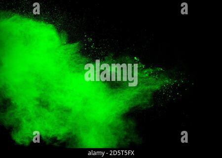 Green powder explosion cloud on black background. Stock Photo