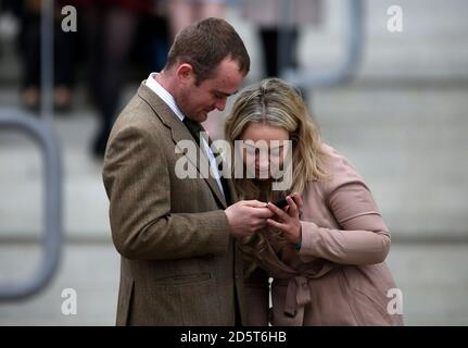 Racegoers enjoy the atmosphere during St Patrick's Day of the 2017 Cheltenham Festival Stock Photo