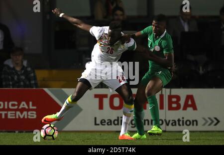 Senegal's Salif Sane, (left) battles for possession of the ball with Nigeria's Kelechi Iheanacho (right) Stock Photo