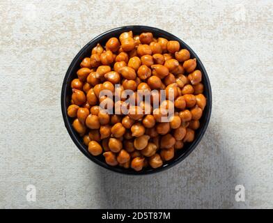 Wet Brown Chickpeas (Kala Chana) in black bowl on light background Stock Photo