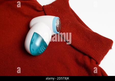 Device for removing lint from wool clothes. Golf with fuzz ball isolated on white background. Stock Photo