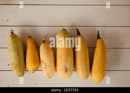 Yellow squashes on a wooden table Stock Photo