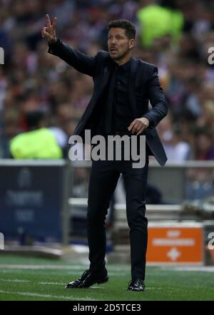 Atletico Madrid's head coach Diego Simeone sits on the bench prior to a ...