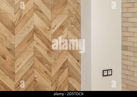 part of living room in warm colors with a finishing wall imitating wooden parquet, brick wall Stock Photo