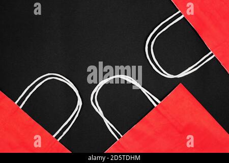 Red paper shopping bags on black background. Copy space. Black Friday sale minimal concept Stock Photo