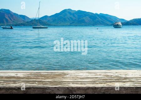 landscape of the beautiful sea, beach in Turkey with wooden table for display products. summer desk sea and sky of blue. Wood table top with sea backg Stock Photo