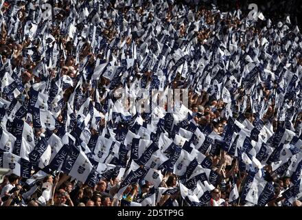 Tottenham Hotspur fans hold up flags to commemorate the final game at White Hart Lane