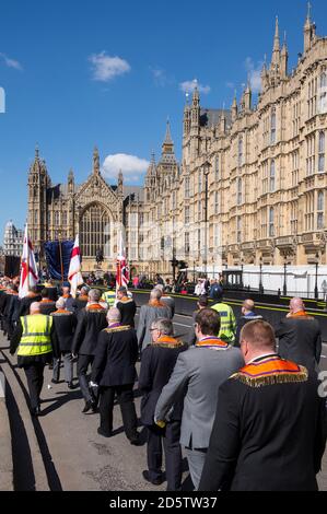 St George's Day Orange parade in City of London being escorted by the Metropolitan Police, England. Stock Photo