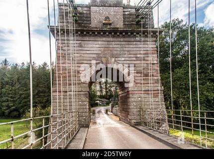 Union Bridge, a 200 year old chain bridge, spans the River Tweed, bridges the borders of England and Scotland. Stock Photo