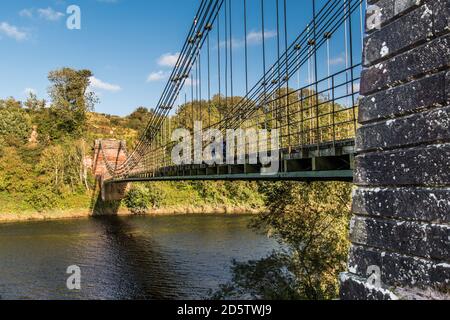 Union Bridge, a 200 year old chain bridge, spans the River Tweed, bridges the borders of England and Scotland. Stock Photo