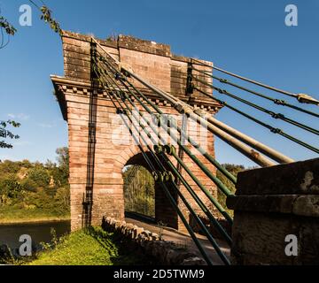 Union Bridge, a 200 year old chain bridge, spans the River Tweed, bridges the borders of England and Scotland. Stock Photo