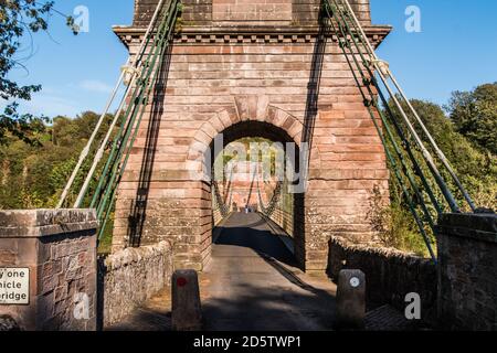 Union Bridge, a 200 year old chain bridge, spans the River Tweed, bridges the borders of England and Scotland. Stock Photo