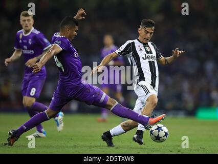 Real Madrid's Casemiro (left) and Juventus' Paulo Dybala battle for the ball during the 2017 Champions League Final held at the National Stadium, Cardiff Stock Photo