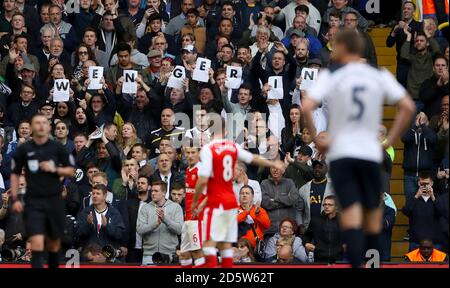 Tottenham Hotspur fans hold up signs reading Wenger In