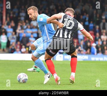 Coventry City's Liam Kelly (left) battles with Grimsby Town's Sam Jones (right)  Stock Photo