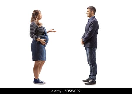Full length profile shot of a pregnant wife talking to her husband isolated on white background Stock Photo