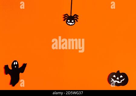 silhouettes of a Ghost, spider and pumpkin made of black paper on an ...