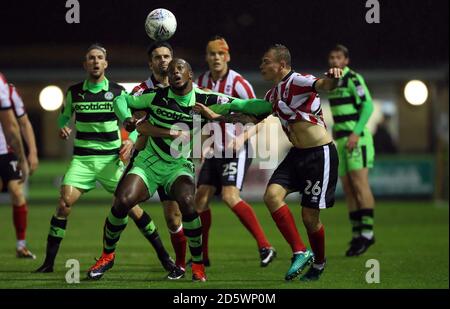 Forest Green Rovers' Shamir Mullings and Lincoln City's Harry Anderson (right) battle for the ball Stock Photo