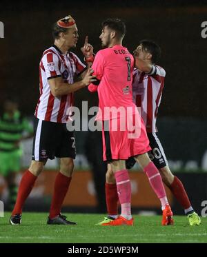 Tempers flare between Lincoln City's Sean Raggett (left) and Forest Green Rovers goalkeeper Bradley Collins after the final whistle Stock Photo