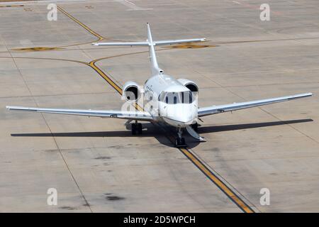 Private jet airplane parked on the taxiway at the airport Stock Photo