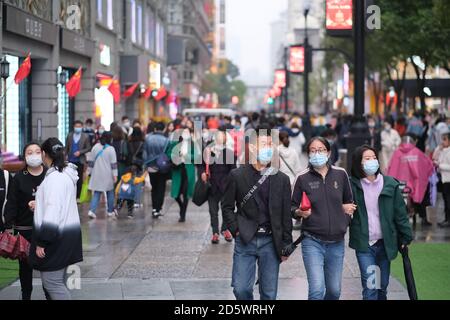 people in face mask to prevent coronavirus, walking on Jianghan Road. Jianghan Road is a famous commercial street in Wuhan Stock Photo