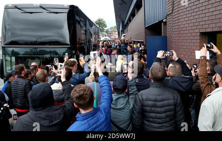 Fans try to get a view of Manchester City's John Stones as he gets off the team bus Stock Photo