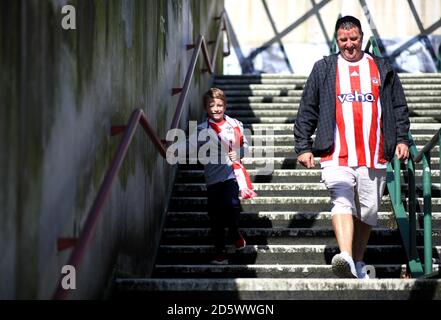 Southampton fans make their way to the stadium prior to the match Stock Photo