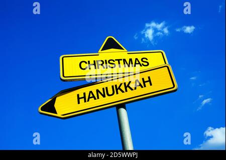 Christmas vs Hanukkah - Traffic sign with two options - celebration of religious holidays and festivals according to christian or jewish tradition Stock Photo