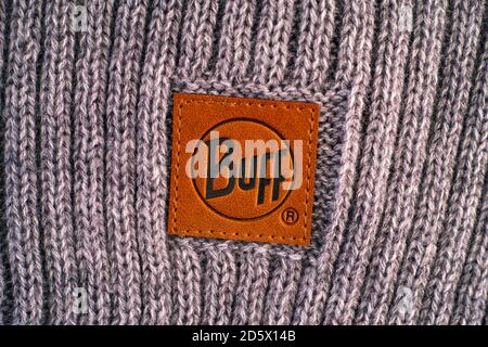 Tambov, Russian Federation - November 16, 2019 Close-up of clothes label Buff on gray knitted backgrounds. Stock Photo