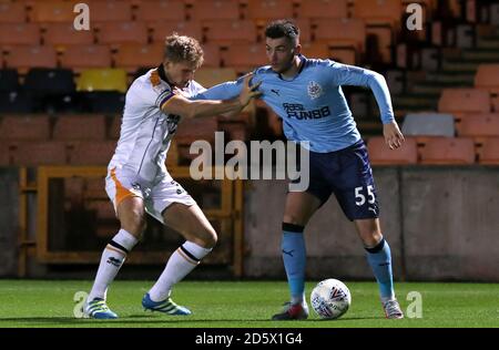 Port Vale's Nathan Smith (left) and Newcastle United U21's Luke Chapman battle for the ball Stock Photo