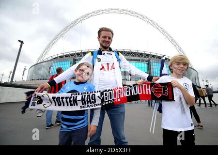 Tottenham Hotspur fans hold up a half and half scarf outside the stadium prior to the match Stock Photo