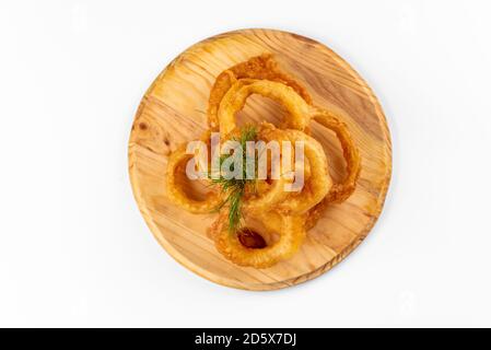 onion rings on a wooden plate on a white background Stock Photo
