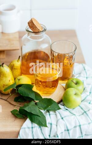 fresh Apple juice in a bottle and glass in the kitchen Stock Photo