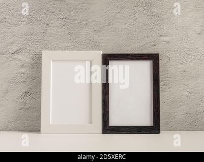 Two empty photo frames on a table or shelf with a copy of the space Stock Photo