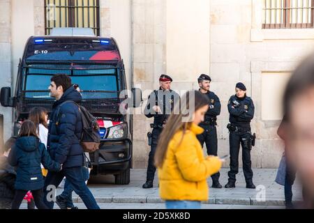 Barcelona, Spain December 23, 2019 Police car and three police men 'mossos d'esquadra' (the autonomous police of Catalonia) on the street with a fusil Stock Photo