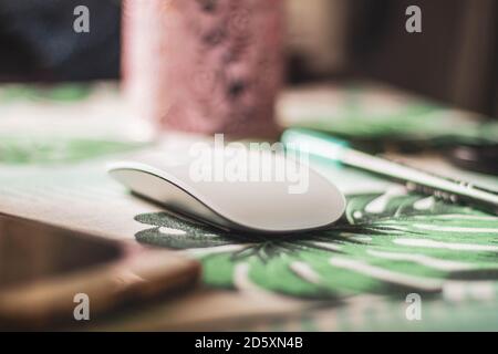 white computer mouse on patterned table Stock Photo