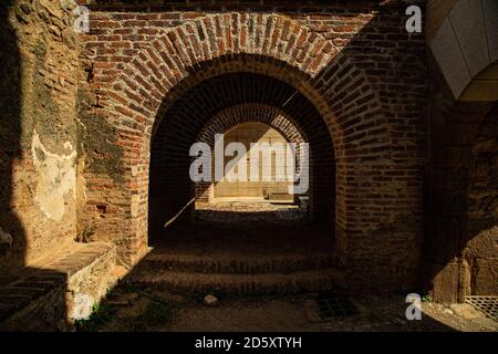 Detail of a red brick Roman arch with a play of light and shadow Stock Photo