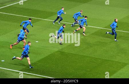 Tottenham Hotspur players warm up prior to kick off Stock Photo