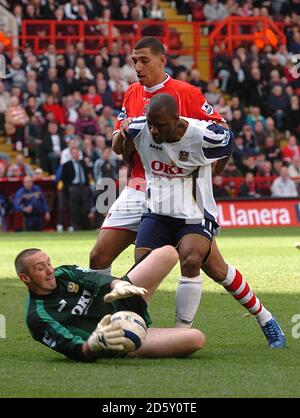 Charlton Athletic's Jay  Bothroyd is held off by Portsmouth's Noe  Pamarot as goalkeeper Dean Kiely makes a save Stock Photo