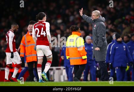 Arsenal manager Arsene Wenger speaks with Arsenal's Hector Bellerin as he leaves teh pitch at half time  Stock Photo
