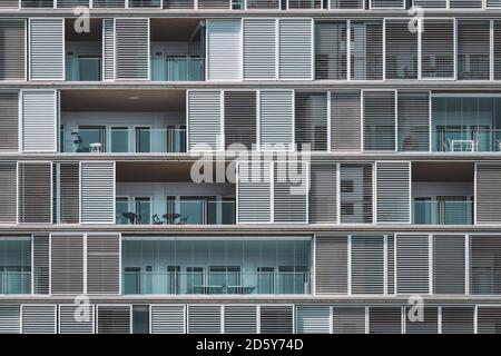 Facade of a residential building with continuous balconies and numbered ...