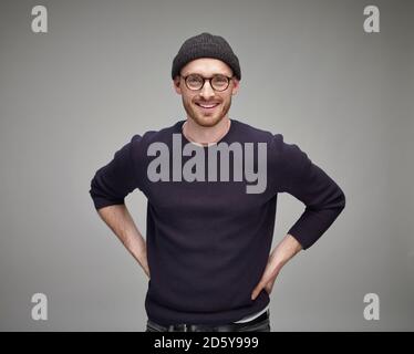 Portrait of man wearing wool cap and glasses Stock Photo