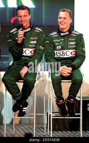 Eddie Irvine (l) chats with new Jaguar teammate Johnny Herbert (r)  Stock Photo