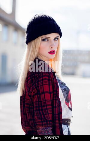 Portrait of stylish blond young woman wearing black wool cap Stock Photo