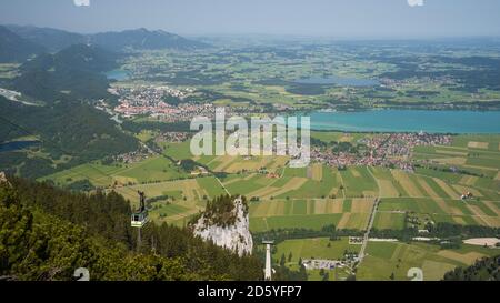 Germany, Bavaria, Swabia, East Allgaeu, Ammergau Alps, Tegelberg cable car and view to Fuessen Stock Photo