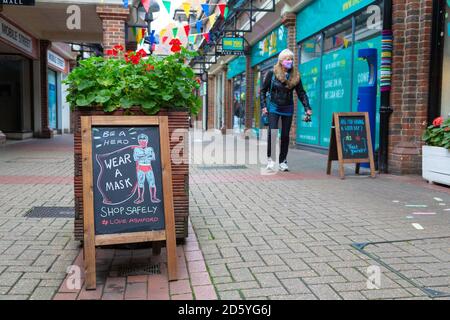 Ashford, Kent, UK. 14th Oct, 2020. Bleak looking high street as more shops have to let and for sale signs on there windows. Be a hero wear a mask sign outside a shop in Park Mall. Photo Credit: Paul Lawrenson-PAL Media/Alamy Live News Stock Photo